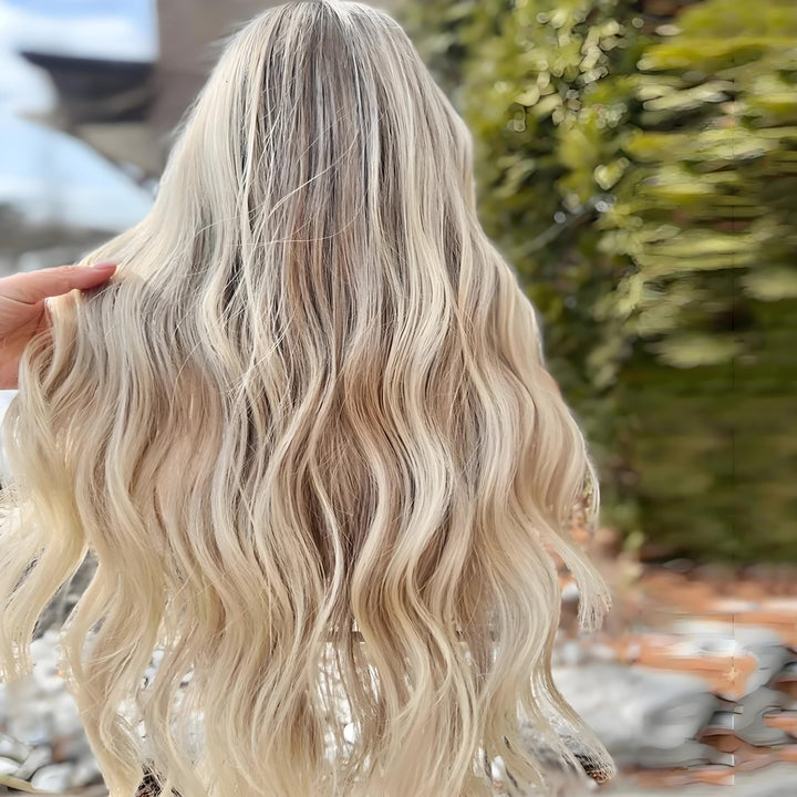 Outdoor back view of long 360 lace wig with blonde brown body waves and natural shine.