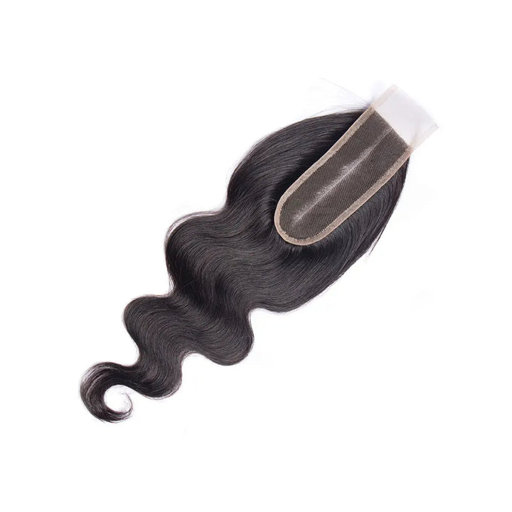 Natural color 2×6 body wave lace closure laid flat, highlighting lace base and wavy texture.