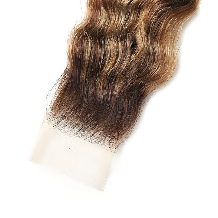 Detailed lace front of 2×6 deep wave lace closure in medium brown with honey blonde highlights, showing lace transparency and natural hairline.