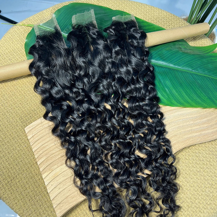 Three natural color 2×6 water wave lace closures displayed together on bamboo rod with defined wave pattern.