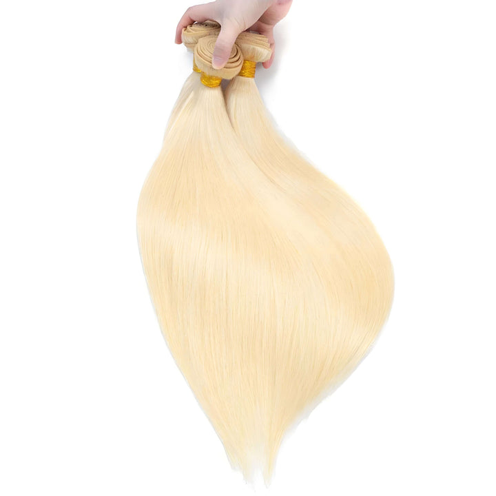 Close-up of 613 blonde straight bundles held in hand, silky smooth strands with natural shine and fullness.