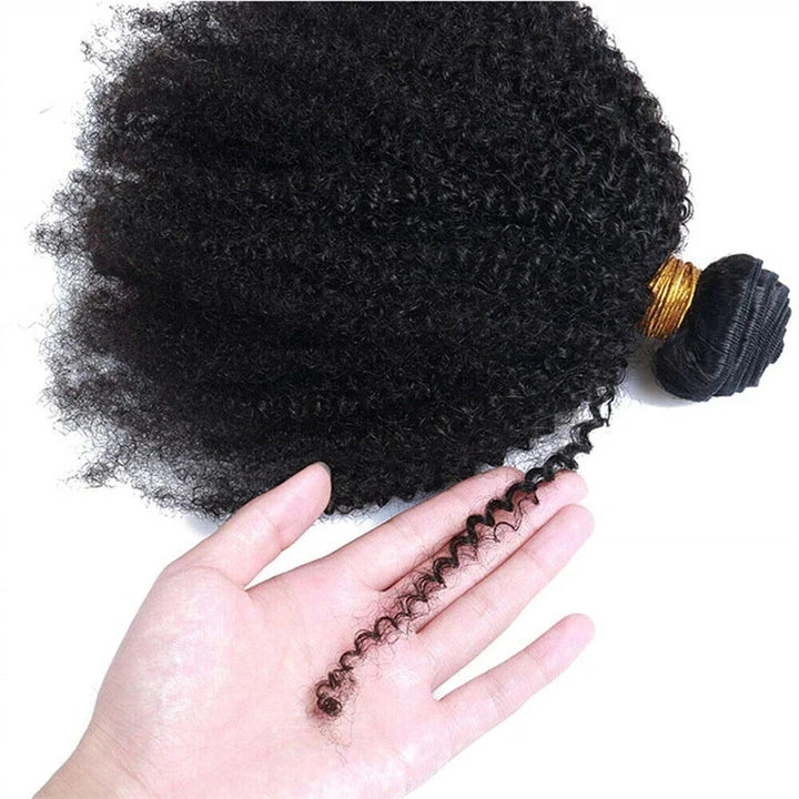 Close-up of Afro Curly bundle held in hand, emphasizing tight curls and springy ends.
