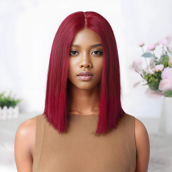 Close-up front view of a woman wearing a straight reddish burgundy bob wig with 2×6 lace closure.