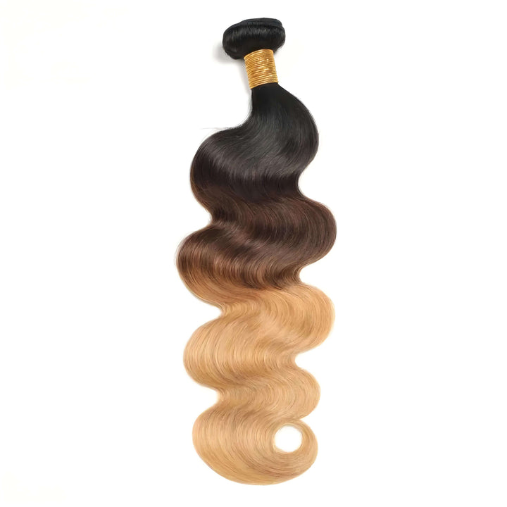 Close-up of single body wave bundle in T1B/4/27 ombre, highlighting glossy waves and natural color blend from black to blonde.
