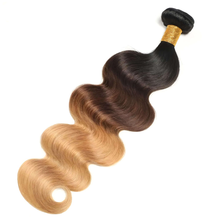 Single bundle of body wave hair in T1B/4/27 ombre, showing transition from off black to medium brown with honey blonde highlights.