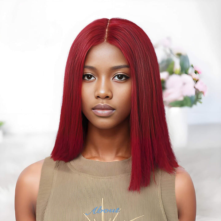 Straight reddish burgundy bob wig on a model with a visible 2×6 lace closure parting in center.