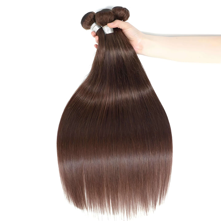 Close-up of chocolate brown straight hair bundles held in hand, silky smooth strands reflecting natural luster.