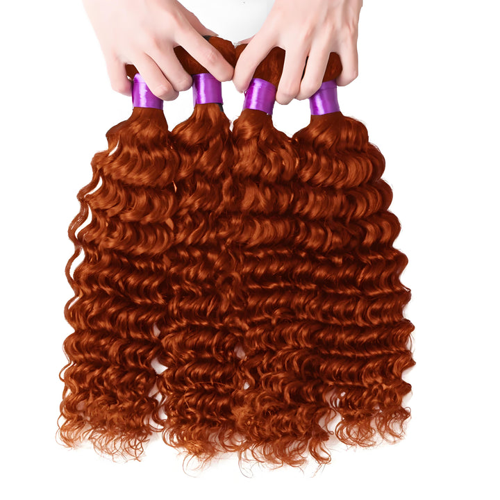 Four ginger deep wave hair bundles held by hand, showcasing consistent curl pattern and rich color.