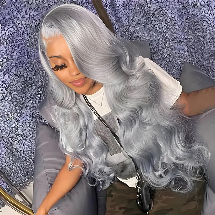 Natural light photo of a model sitting in a salon chair with long body wave silver grey hair flowing over her shoulder.