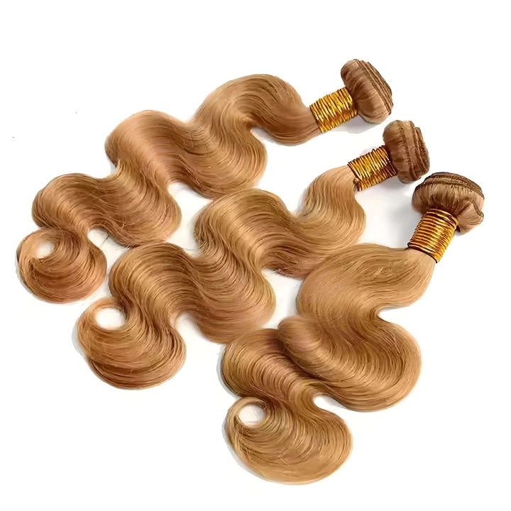 Side angle close-up of honey blonde body wave bundles, soft silky strands with reinforced golden weft.
