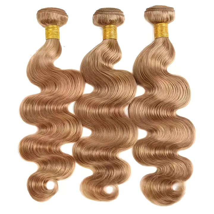 Three bundles of honey blonde body wave extensions arranged in a row, smooth shiny waves with natural bounce.
