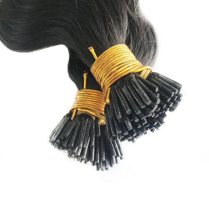 Close-up view of EuxmeHair I-tip hair extensions, showing neat keratin tips wrapped with golden thread.