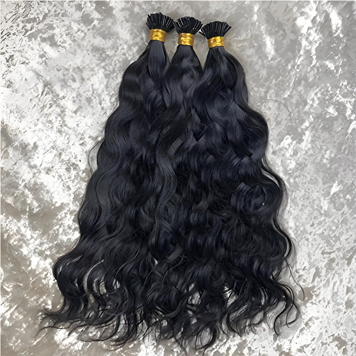 Models wearing EuxmeHair I Tip Natural Wave Hair Extensions in natural black, showing soft waves and volume.