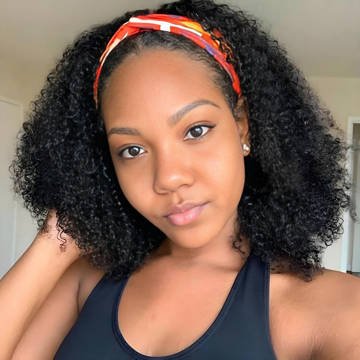 Close-up of model wearing Jerry Curly headband wig in natural color with orange patterned headband, soft curls framing the face.