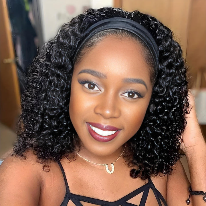 Smiling woman wearing kinky curly bob headband wig with classic black headband, medium-length curls styled naturally.