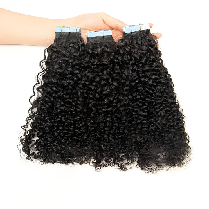 Close-up of natural color kinky curly texture on tape-in hair extensions, highlighting tight curls and shine.