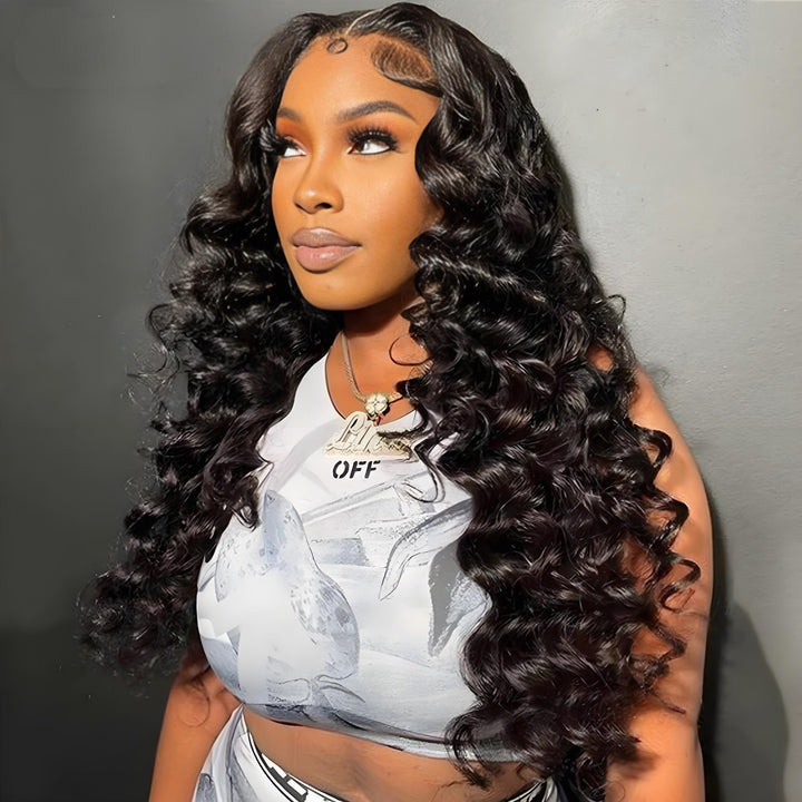 Model showing off long 5x5 HD lace loose wave wig in natural color with defined waves.