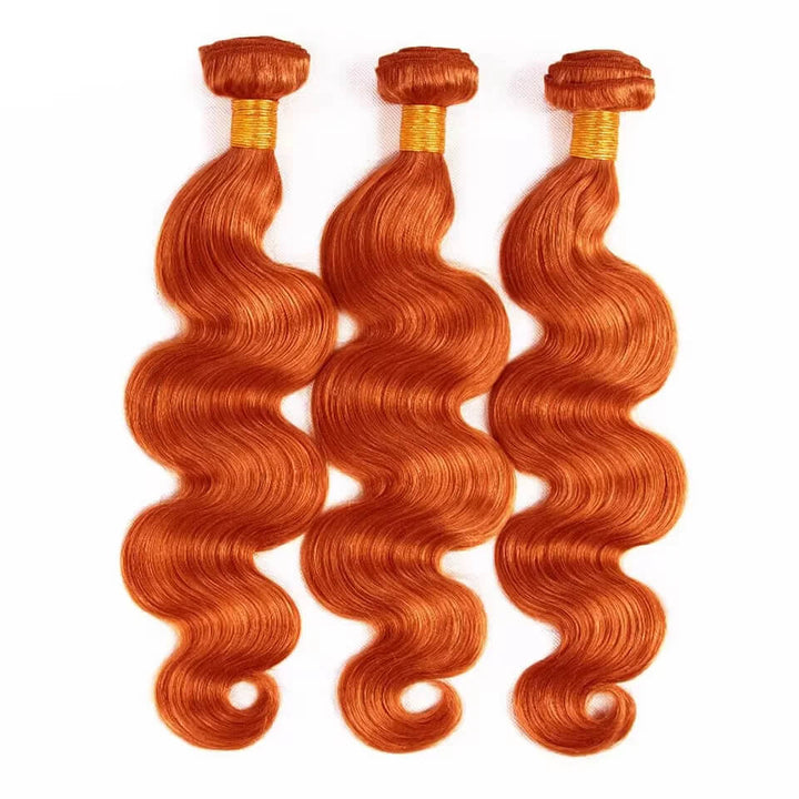 Three orange body wave hair bundles laid flat on white background, bouncy defined waves with glossy finish.