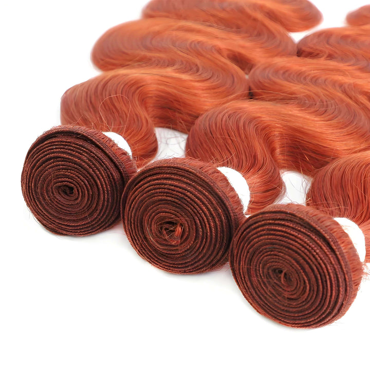 Close-up of orange body wave bundle wefts, reinforced double machine construction for durability.