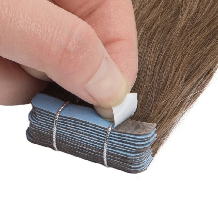 Top view of straight chocolate brown tape-in hair extensions arranged to display smooth finish and color consistency.