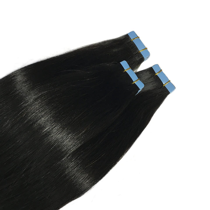 Close-up of straight tape-in hair extensions showing top adhesive tabs and silky natural texture.