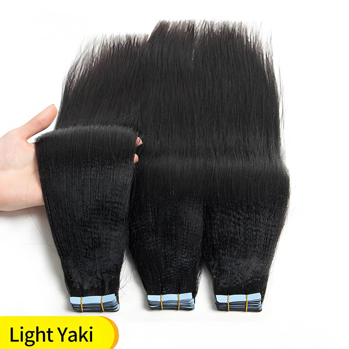 Close-up of light Yaki straight tape-in hair extensions showing coarse texture and blue tape tabs for seamless installation.
