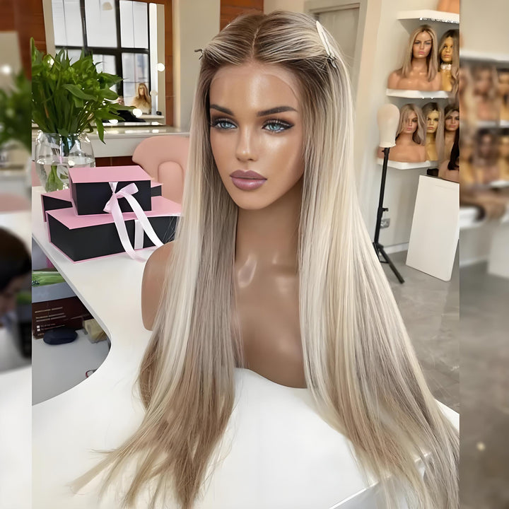 Mannequin showing full view of ash blonde straight wig with dark roots, styled center-part and pinned sides in indoor light.
